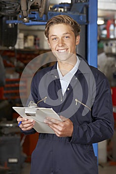 Portrait Of Apprentice Mechanic In Auto Repair Shop