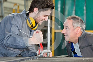 Portrait apprentice working with engineer