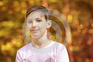 Portrait of an approximately 11-year-old boy. Nice bokeh in the background