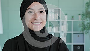 Portrait Arab girl Islamic Muslim woman wearing black hijab in office looking at camera happy Arabian businesswoman