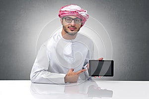 Portrait of an Arabian businessman presenting on a pad