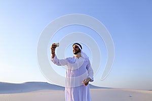 Portrait of Arabian sheikh man with gadget that communicates in