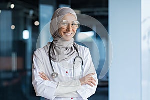 Portrait of Arabic female doctor in modern clinic, Muslim woman wearing hijab glasses