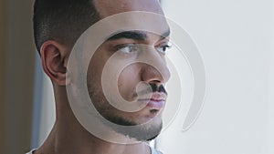 Portrait of arabic young adult ethnic man brunette Spaniard guy male head face looking out window with serious worried