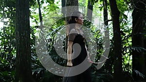 Portrait of archery woman walking fearless and bravely in the jungle