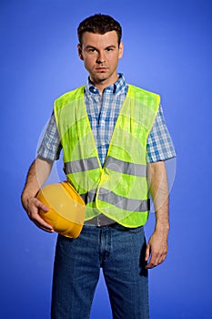 Portrait of architect in coveralls holding hardhat