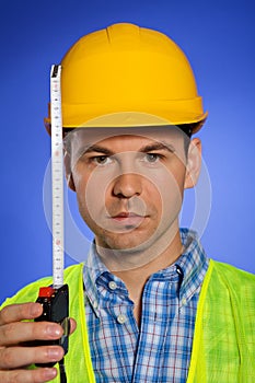 Portrait of architect in hardhat holding tape measure