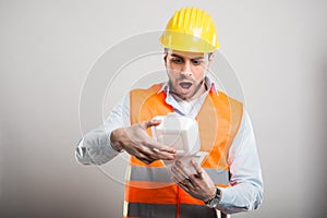 Portrait of architect opening lunch box looking amassed