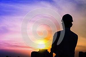 Portrait of architect silhouette wear a helmet at construction site with crane background and sunset