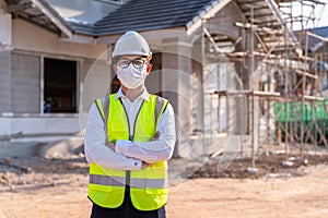 Portrait of Architect wearing a mask on a building construction site, Homebuilding Ideas and Prevention of Coronavirus Disease