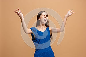 Portrait of an argue woman looking at camera on a pastel background