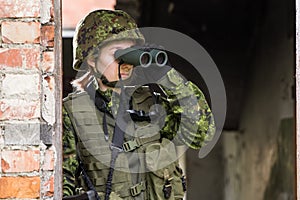 Portrait of armed woman with camouflage