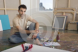 Portrait Of Artist With Painting Tools In Studio photo