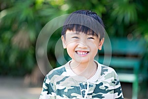 Portrait of Asia kid boy smiling with teeth and gums.