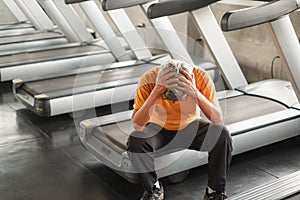 Portrait asia senior man have a backache after running treadmill in fitness gym