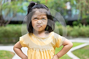 Portrait of an Asian angry and sad little girl. The emotion of a child when tantrum and mad, expression of grumpy emotion. Kid