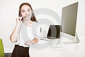 Portrait of Asian beautiful smiling woman customer support phone operator in office space background. Concept call center job