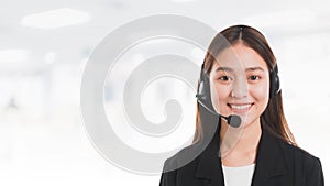 Portrait of Asian beautiful smiling woman customer support phone operator in office space banner background and copy space.Concept