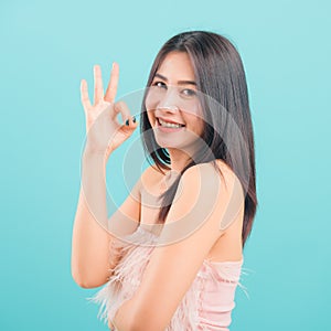 Portrait asian beautiful woman smiling showing finger OK sign and her looking to camera