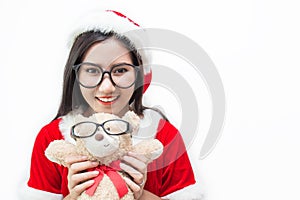 Portrait of asian beautiful woman wearing santa custume and glasses holding teddy bear photo