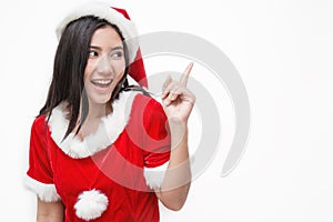Portrait of asian beautiful woman wearing santa custume with her finger point up photo