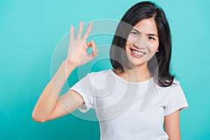 Portrait Asian beautiful young woman made finger OK symbol sign