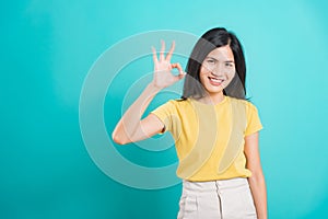 Portrait Asian beautiful young woman made finger OK symbol sign