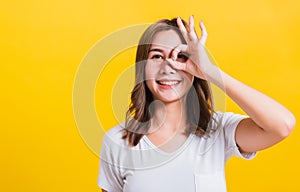 Portrait Asian beautiful young woman made finger OK symbol sign