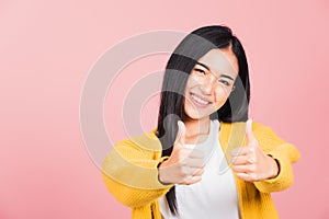 .Portrait Asian beautiful young woman smile she standing made finger thumbs up, Ok sign to a