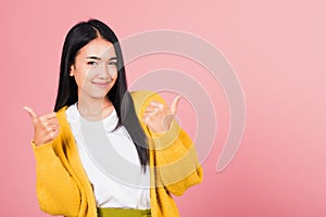 .Portrait Asian beautiful young woman smile she standing made finger thumbs up, Ok sign to agree studio shot isolated