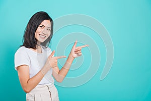 Portrait Asian beautiful young woman standing pointing finger up