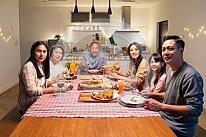 Portrait of Asian Big happy family having dinner together in house. Senior elder grandparent spend time with young relative