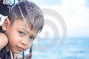 Portrait of Asian Boy on boat Background blurry sea