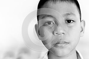 Portrait of asian boy crying with tear on his face in black and white.