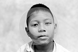 Portrait of asian boy crying with tear on his face in black and white.