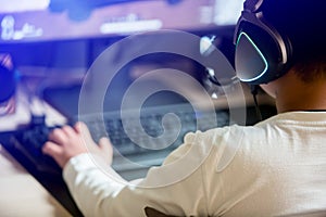 Portrait of asian boy gamer playing games on computer in the room at home