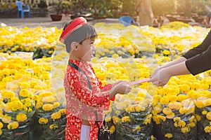 Portrait of a Asian boy on traditional festival costume. Cute little Vietnamese boy in ao dai dress smiling. Tet holiday. Lunar Ne