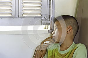 Portrait of asian boy on the train background window views