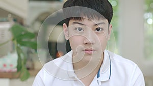 Portrait of Asian boy use brace looking at camera with smile face