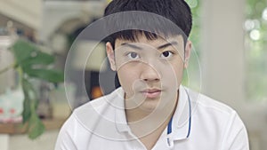 Portrait of Asian boy use brace looking at camera with smile face