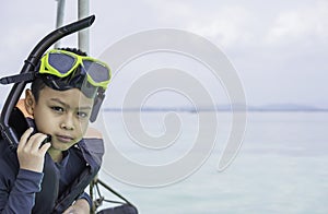 Portrait Asian Boy wearing a life jacket and scuba diving Background sea