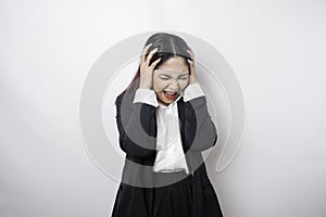 A portrait of an Asian business woman wearing a black suit isolated by white background looks depressed