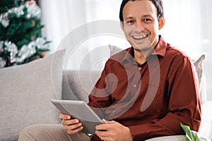 Portrait of asian businessman smiling with digital tablet