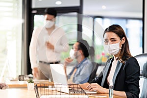 Portrait asian businesswoman working in new normal and social distance office photo