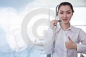 Portrait Asian callcenter operator thumbs up. Helpdesk support phone call customer care female staff smiling with headset good