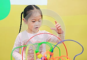 Portrait of Asian child girl playing educational toy for brain development at kids room