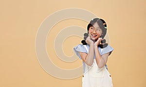 portrait Asian child Thoughtful schoolgirl thinking and looking isolated on color copy space background. making choice