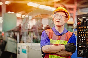 Portrait of Asian Chinese labor happy worker smiling looking for the future in a heavy industrial factory