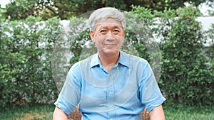 Portrait Asian Chinese senior man feeling happy smiling at home. Older male relax toothy smile looking to camera while lying in