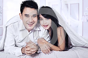 Portrait of asian couple on bed